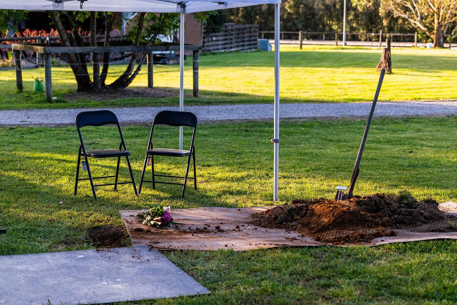 A canopy and chairs set up for a family's farewell in the grounds