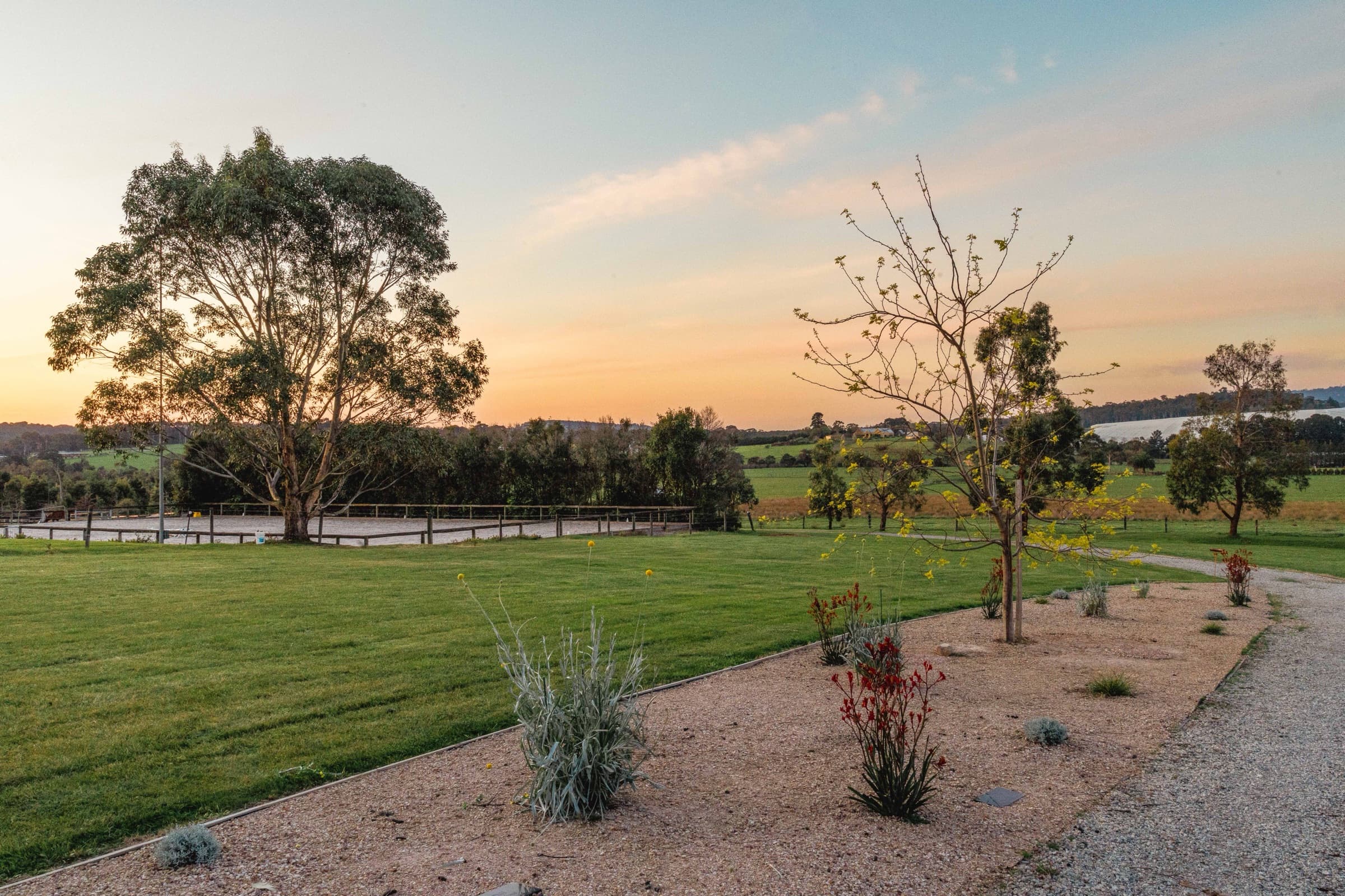 The memorial garden at dusk with plaques set in the lawn